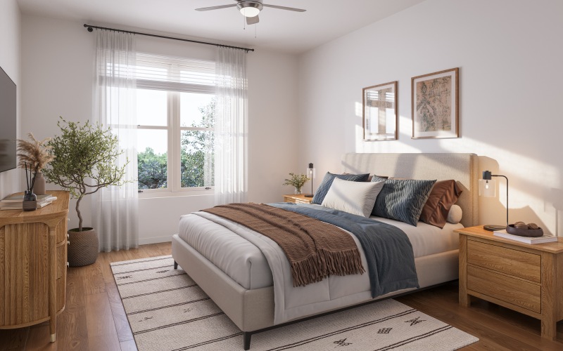 Primary bedroom with large bed two night stands, dresser and large windows