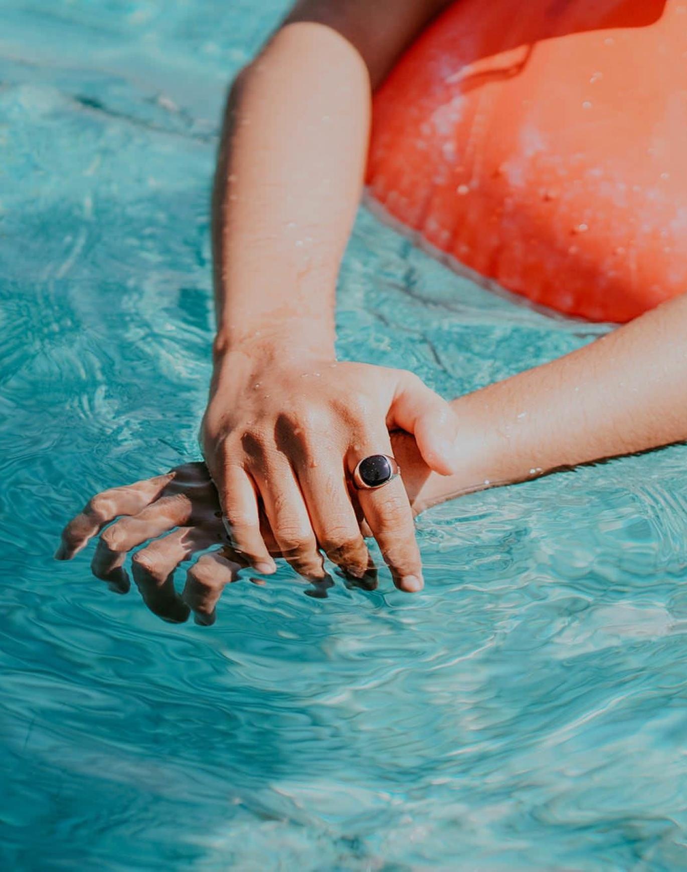 woman relaxes on a floatie in swimming pool