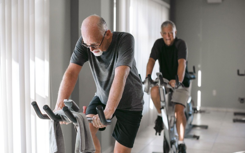 two men working out on a bicycle